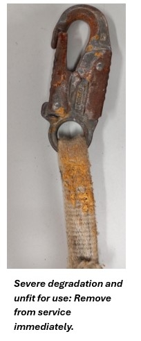 Damaged stitching on a fall protection harness strap indicating equipment failure risk