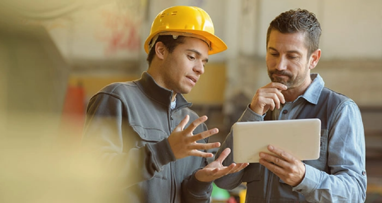 Image of two men discussing continuous improvement in workplace