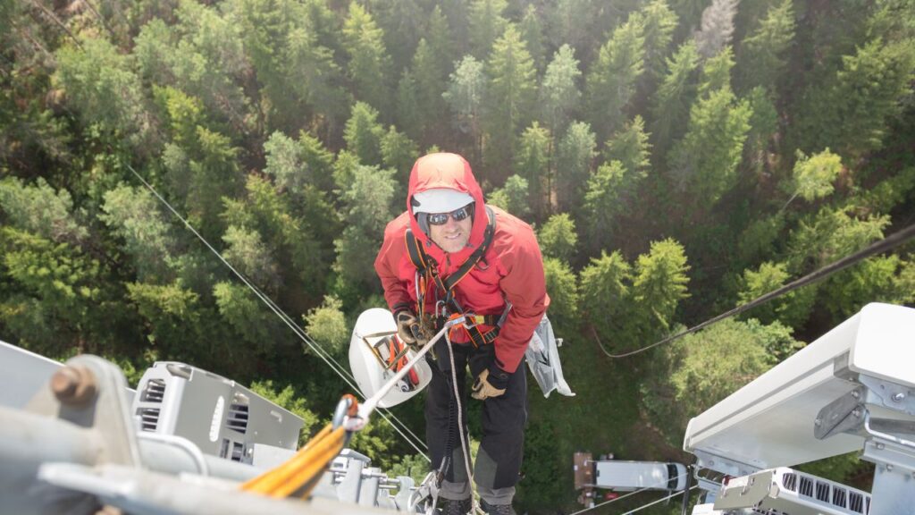 Image of safety worker working at heights following fall protection.